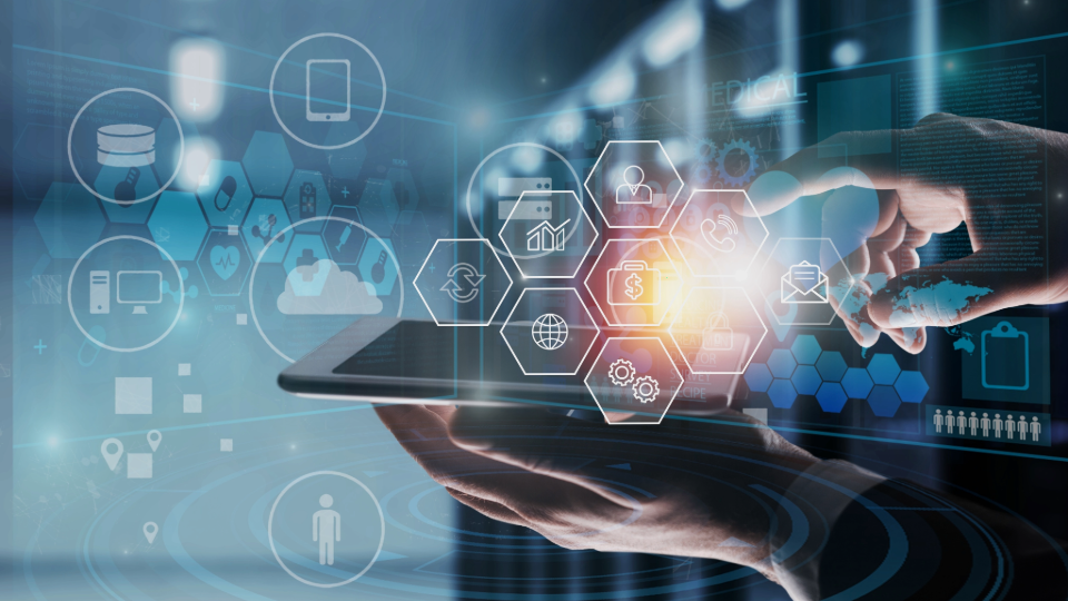 A hand holds a tablet with digital icons and graphics floating above it in a technological network.